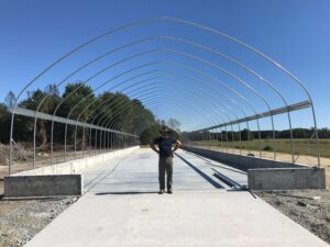 Phinite's Jordan Phasey stands in front of a sludge dryer under construction